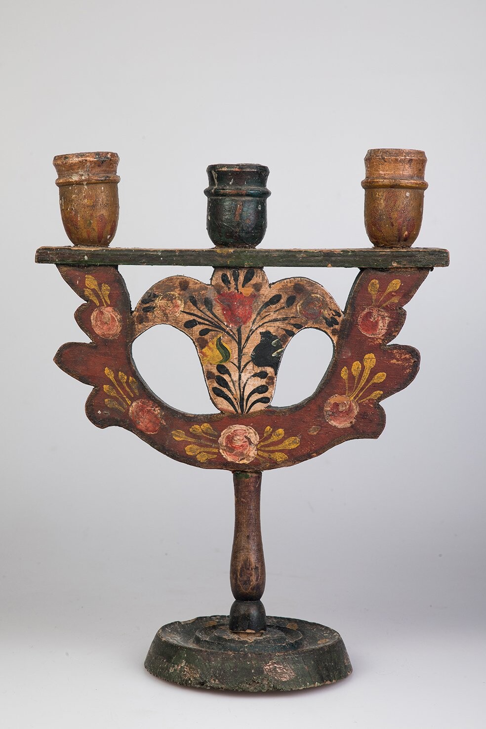 Свічник-трійця, Івано-Франківська обл., кін. ХІХ ст. Дерево, фарби; вирізування, токарна техніка, столярна техніка, розпис. Колекція Музею Івана Гончара.